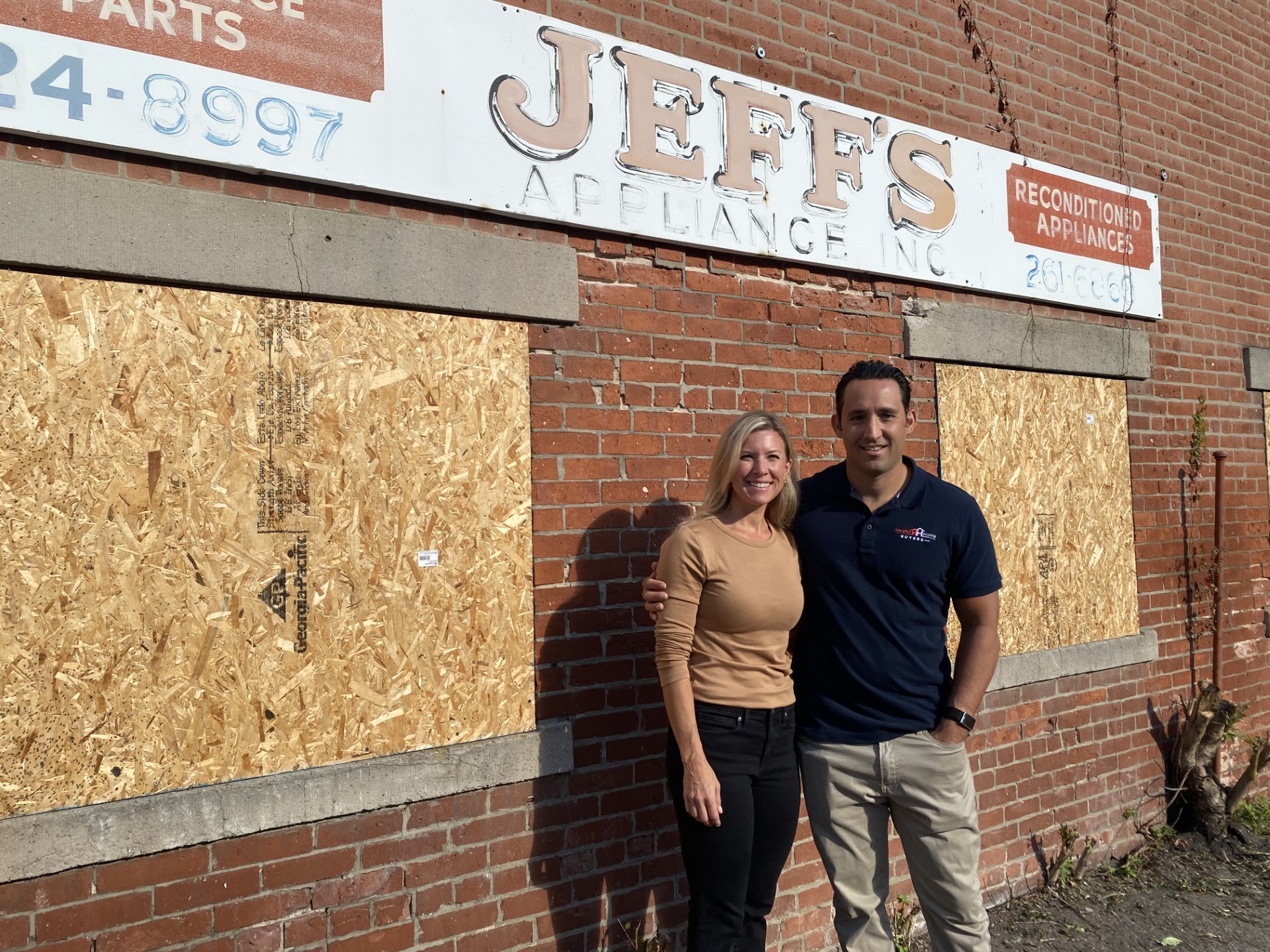 Picture of Helpful Home Buyer's owners in front of Jeff's appliance store